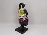 figurine of a black and white bird with a red heart on it ' s chest