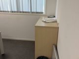 a small room with a desk and a chair in it