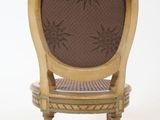 a wooden chair with a brown upholstered seat