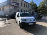a white van parked in front of a building