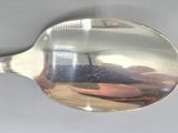 a silver spoon with a reflection of a person in it