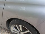 a close up of a car ' s tire on the side of the road
