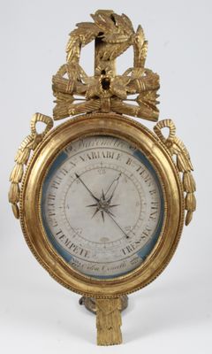 a gold clock with a bird on top of it
