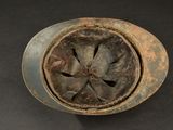 a rusted metal object on a black surface