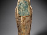 an ancient egyptian statue of a man with a blue face