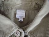 a close up of a buttoned shirt with a tag on it