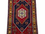 a red, blue and yellow rug with a geometric design
