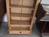 a wooden bookcase with a drawer on top of it