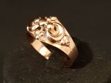 an image of a gold ring on a black surface