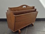 a wooden magazine rack with a magazine holder on it