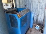 a blue machine that is next to a blue container