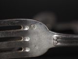 a close up of a fork on a table