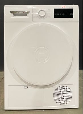 un sèche-linge blanc posé par terre près d'un mur noir