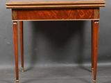 a small table with a wooden top and brass trimmings on the legs
