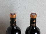 two bottles of wine that are sitting on a table