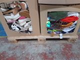 two cardboard boxes with shoes in them on a pallet