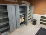 a room that has a bunch of shelves and a trash can in it
