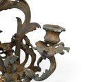 a large metal candelier with three candles on it