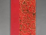 a red notebook with a floral design on it