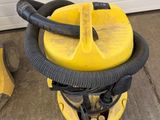 a close up of a yellow and black vacuum cleaner on the ground