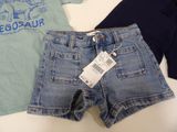 two pairs of shorts and a t - shirt on a table