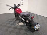 a red motorcycle that is parked on a checkered floor