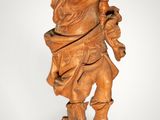 an image of a wooden statue of a man holding a baseball bat