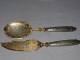 two spoons that are sitting on a table