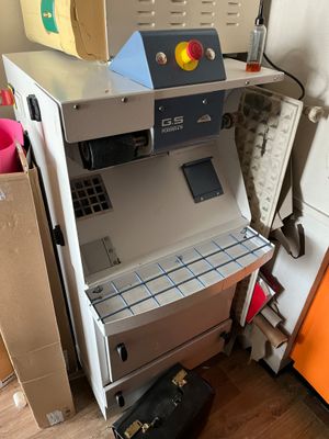 a machine that is sitting next to an orange refrigerator