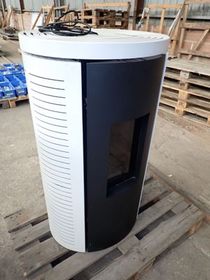 a black and white stove sitting on a pallet in a warehouse