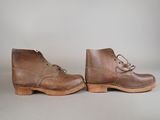 a pair of brown leather boots with laces on them