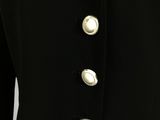 a close up of a black jacket with silver buttons on it