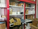 boxes and boxes are stacked on shelves in a storage room