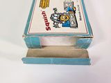 a small box with a picture on it on a white surface