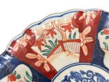 a blue and red plate with a fan design on it