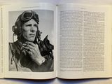 a black and white photo of a man in a pilot ' s helmet