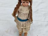 a doll that is standing on a white plate