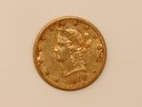 a close up of a gold coin on a white surface