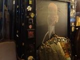 a large picture of a man holding a purse in a room