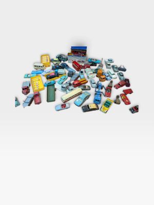a pile of toy cars on a white surface