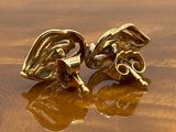 a pair of earrings that are sitting on a table