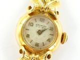 an image of a woman ' s watch with a gold bracelet