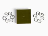 a close up of a book with a green cover and two metal letters