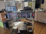 a glass display case with a lot of dvds in it