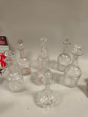 a lot of glass bottles that are sitting on a table
