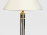 a pair of brass and glass table lamps with a white shade
