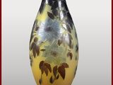 un vase jaune orné de fleurs noires et blanches