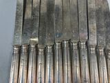 several knives are lined up in a row on a table