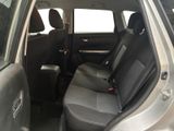 the back seats of a silver car with a black seat belt