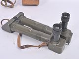 two binoculars sitting on top of a table next to each other